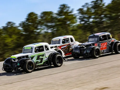 Legends cars racing three-wide at Cordele Motor Speedway